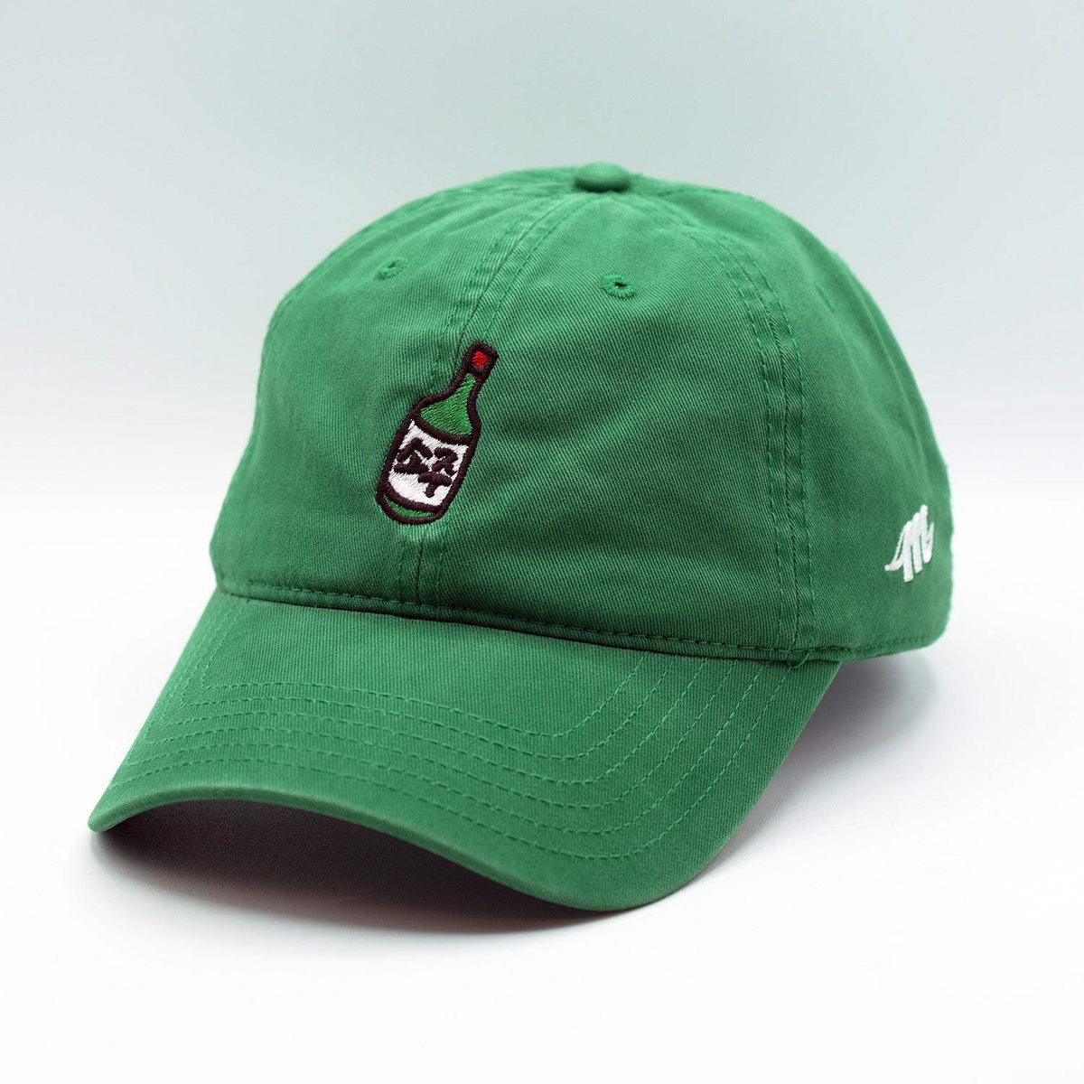 Green cotton dad hat with a curved brim, embroidered Soju bottle motif, and small white side logo.