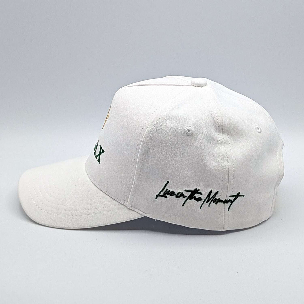 Relax - Premium Suede Snapback Hat in white with a curved brim, green embroidery, and “Live in the Moment” script