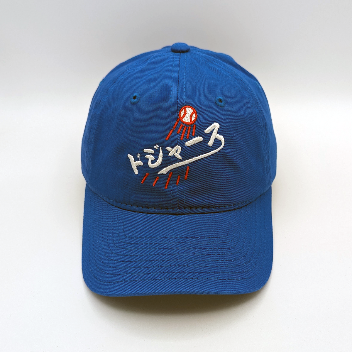 Premium Japanese Dodgers Dad Hat, royal blue cotton cap with white Japanese lettering and red embroidered baseball detail.